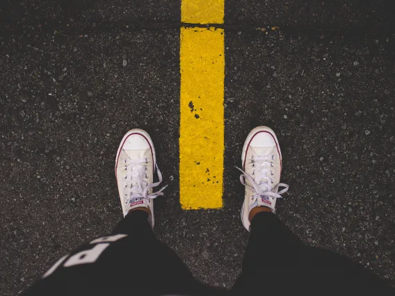 Person with shoes on the road