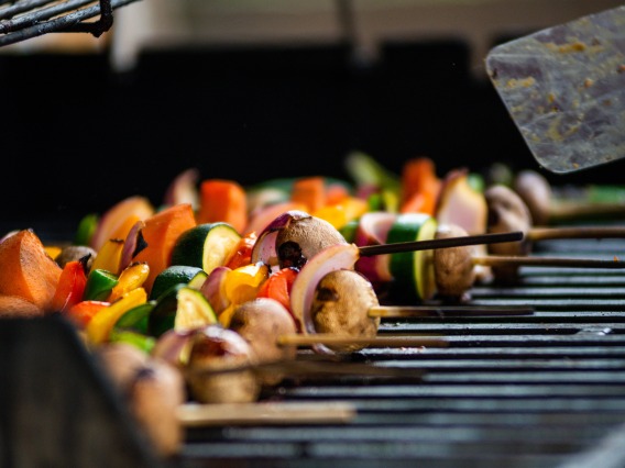 Kabobs with peppers, zuchinni, meat, and mushrooms on a grill