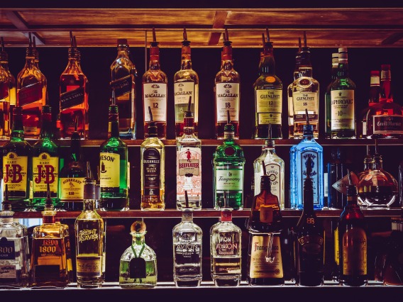 Liquor displayed on a shelf behind a bar