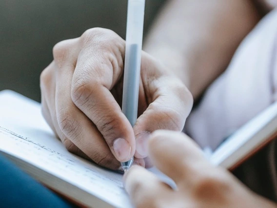 Person writing in journal 