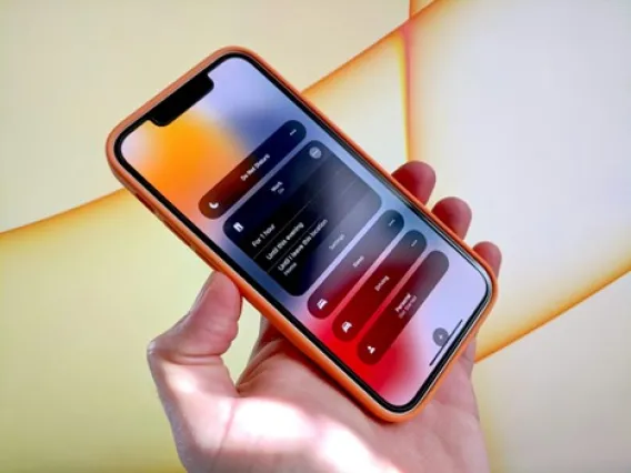 Hand holding an iPhone with Do not disturb setting