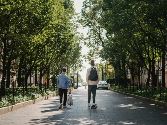 Male skateboarder riding near friend in park