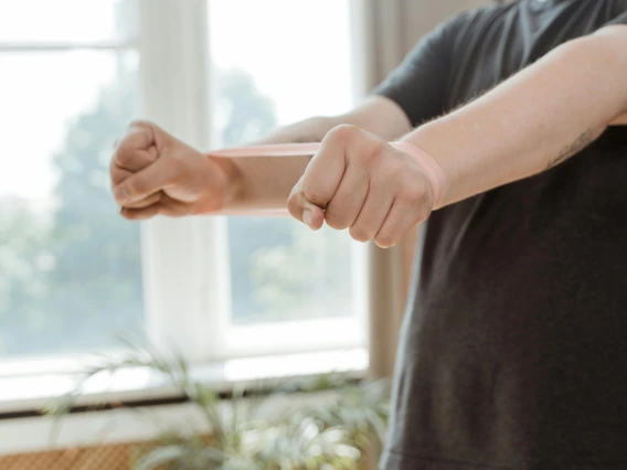 a person wearing a resistance band around their wrists