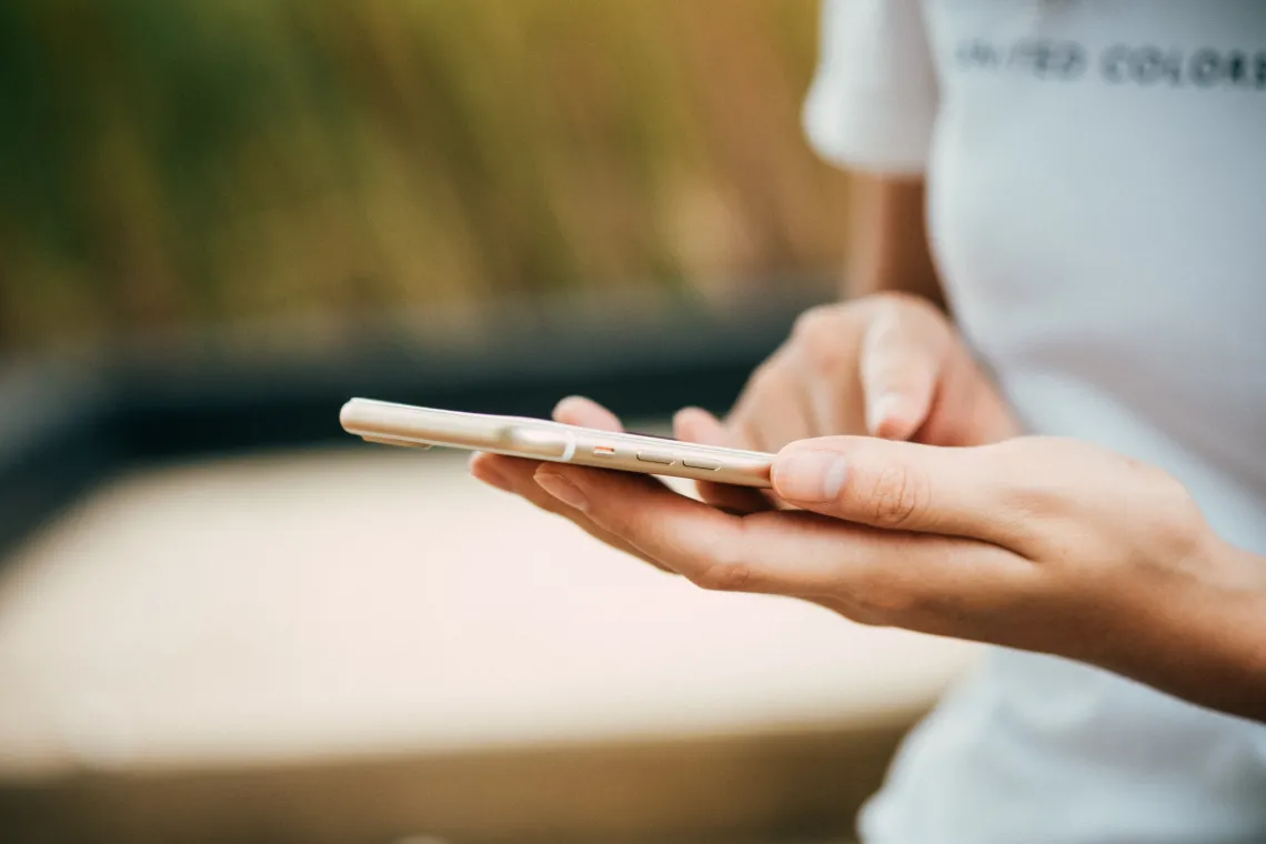 Hands holding a cell phone