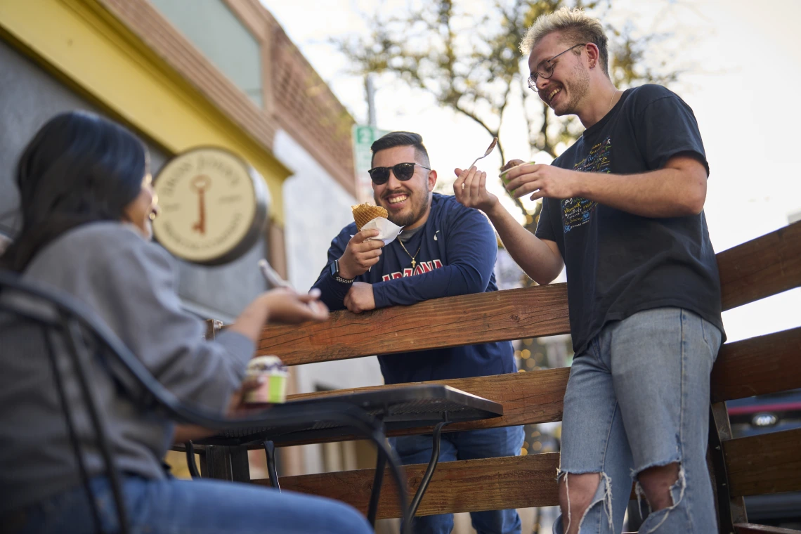 3 people eating ice cream outside