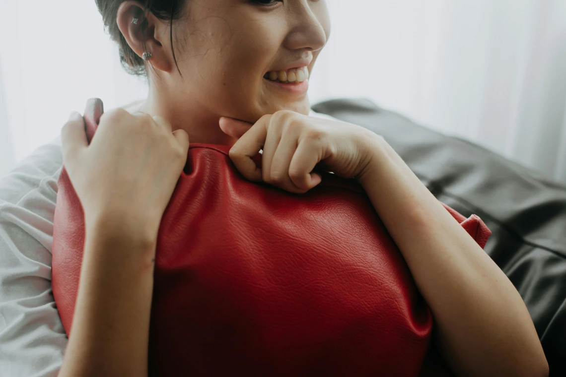 person hugging a pillow