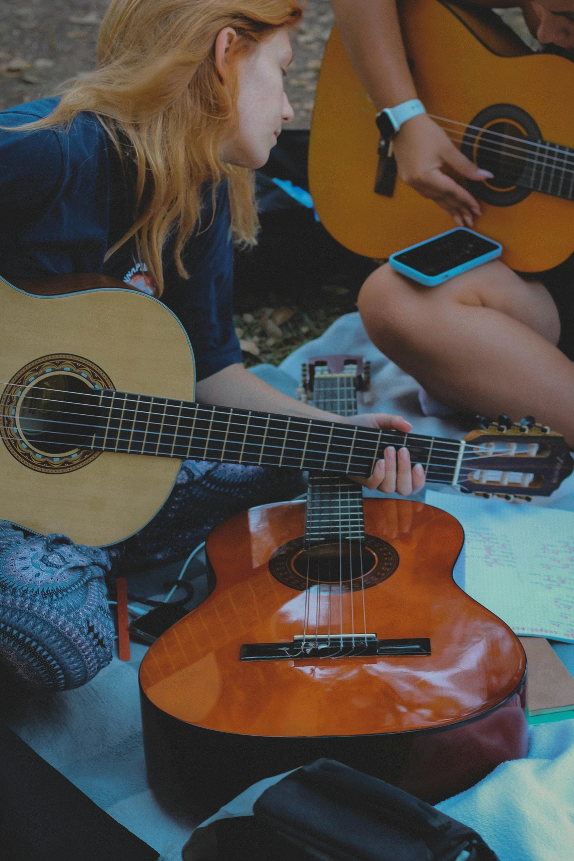 two people playing acoustic guitar